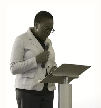 Pastor Margaret speaking at a lectern
